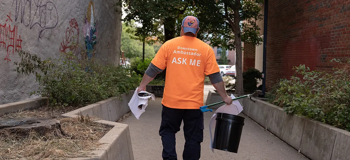 Ambassador carrying cleaning supplies